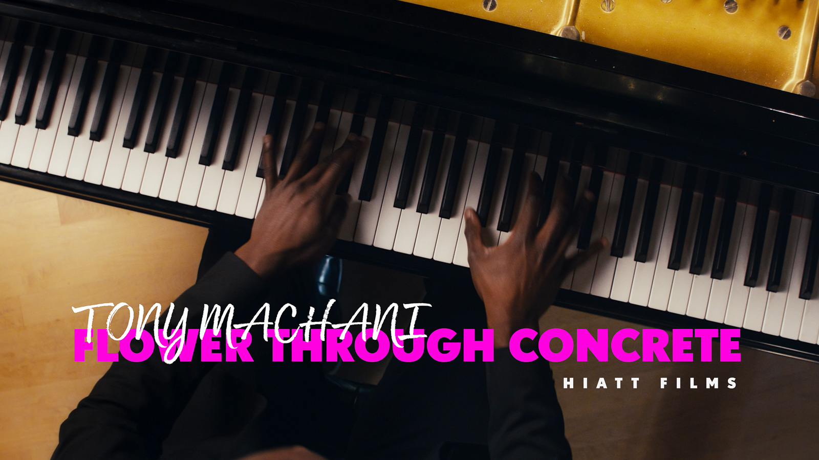 Music video thumbnail showing a pianist playing a grand piano from an overhead cinematic angle