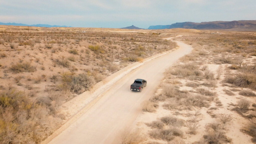 Aerial shot of truck driving through desert landscape during cinematic video production