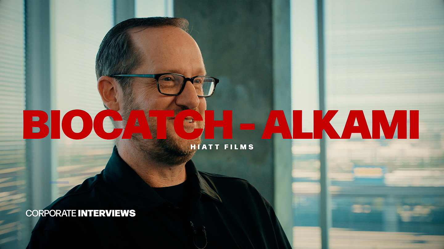 Corporate interview subject speaking on camera in modern office setting filmed by Hiatt Films