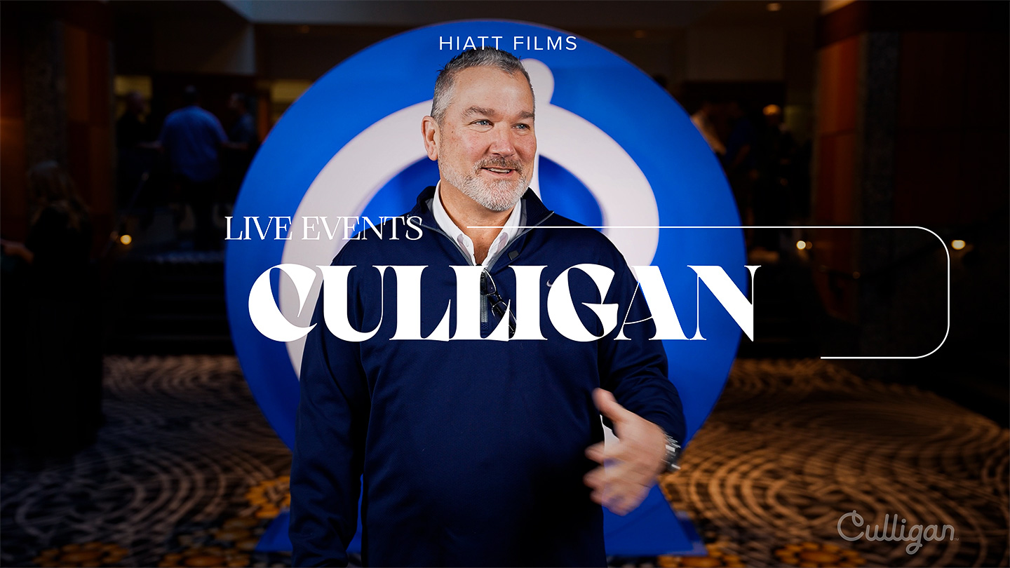 Corporate event interview filmed on location with branded backdrop by Hiatt Films