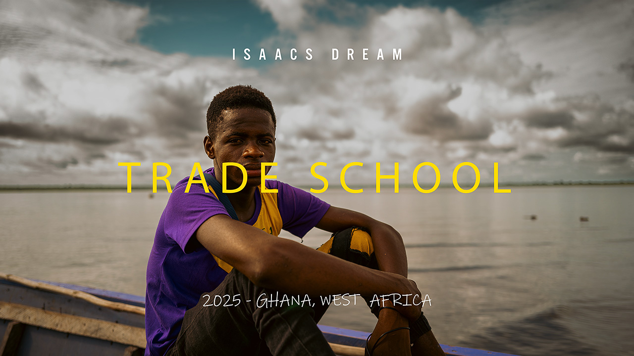 Young man seated by water in Ghana filmed for trade school documentary