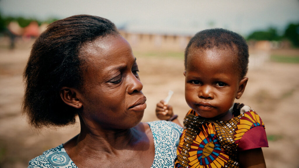 Cinematic portrait of a woman holding a child outdoors in natural light, filmed by Hiatt Films