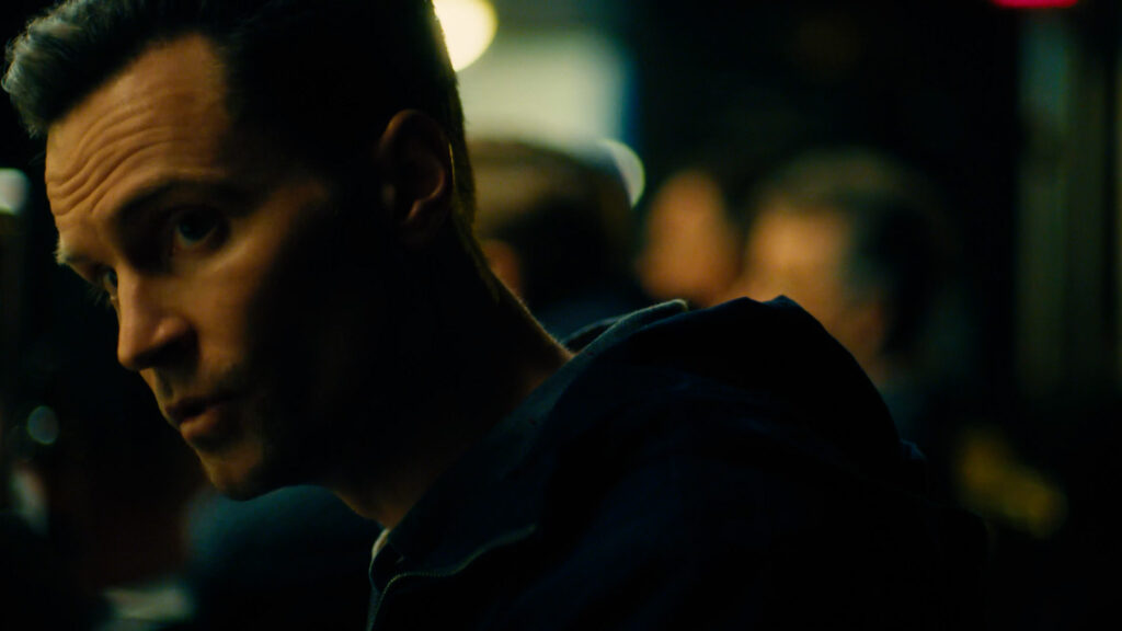 Cinematic video thumbnail of man in dimly lit interior environment