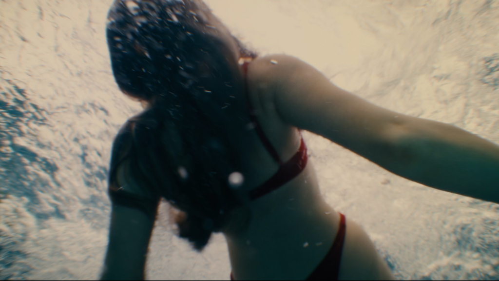 Woman underwater in cinematic slow-motion scene