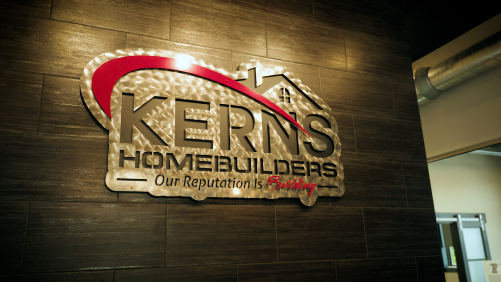Kearns Homebuilders logo sign mounted on interior wall with lighting